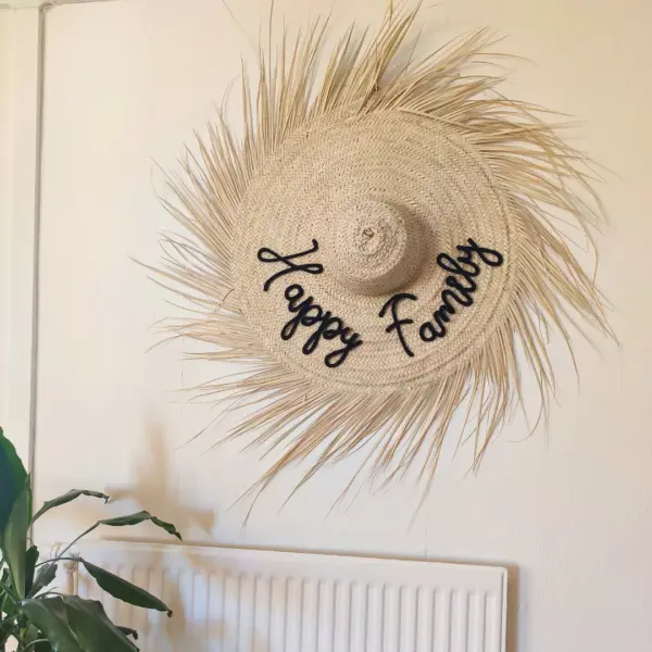 Elevate your space with this handwoven palm leaf wall hat with natural raffia fringes, blending authentic craftsmanship and boho charm. Made from sustainable materials, each piece is unique and eco-friendly. ✨ Why you’ll love it: Authentic Craftsmanship – Handwoven with care, showcasing natural variations that make every hat one of a kind. Natural Materials – Crafted from lightweight, durable palm leaves. Boho Fringe Design – Adds texture and warmth, perfect for wall décor or practical use. Customizable – Personalize with a name or meaningful word in the color of your choice for a unique touch. 📏 Available Sizes: S: 50 cm diameter (without fringes) L: 60 cm diameter (without fringes) 👉 A personalized boho statement piece that doubles as wall art and a thoughtful gift, bringing nature and style into your home.